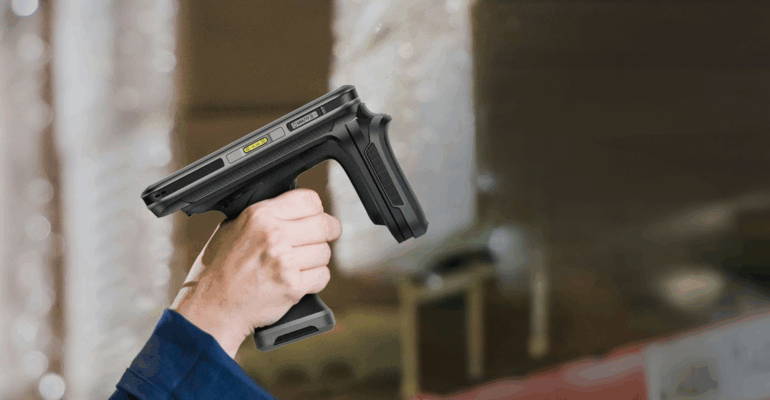 A person holding a lightweight RFID handheld reader in a warehouse environment, illustrating efficient asset tracking and inventory management.