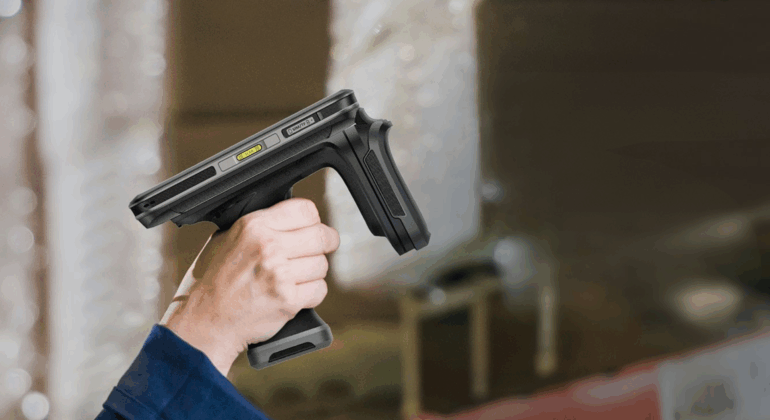 A person holding a lightweight RFID handheld reader in a warehouse environment, illustrating efficient asset tracking and inventory management.